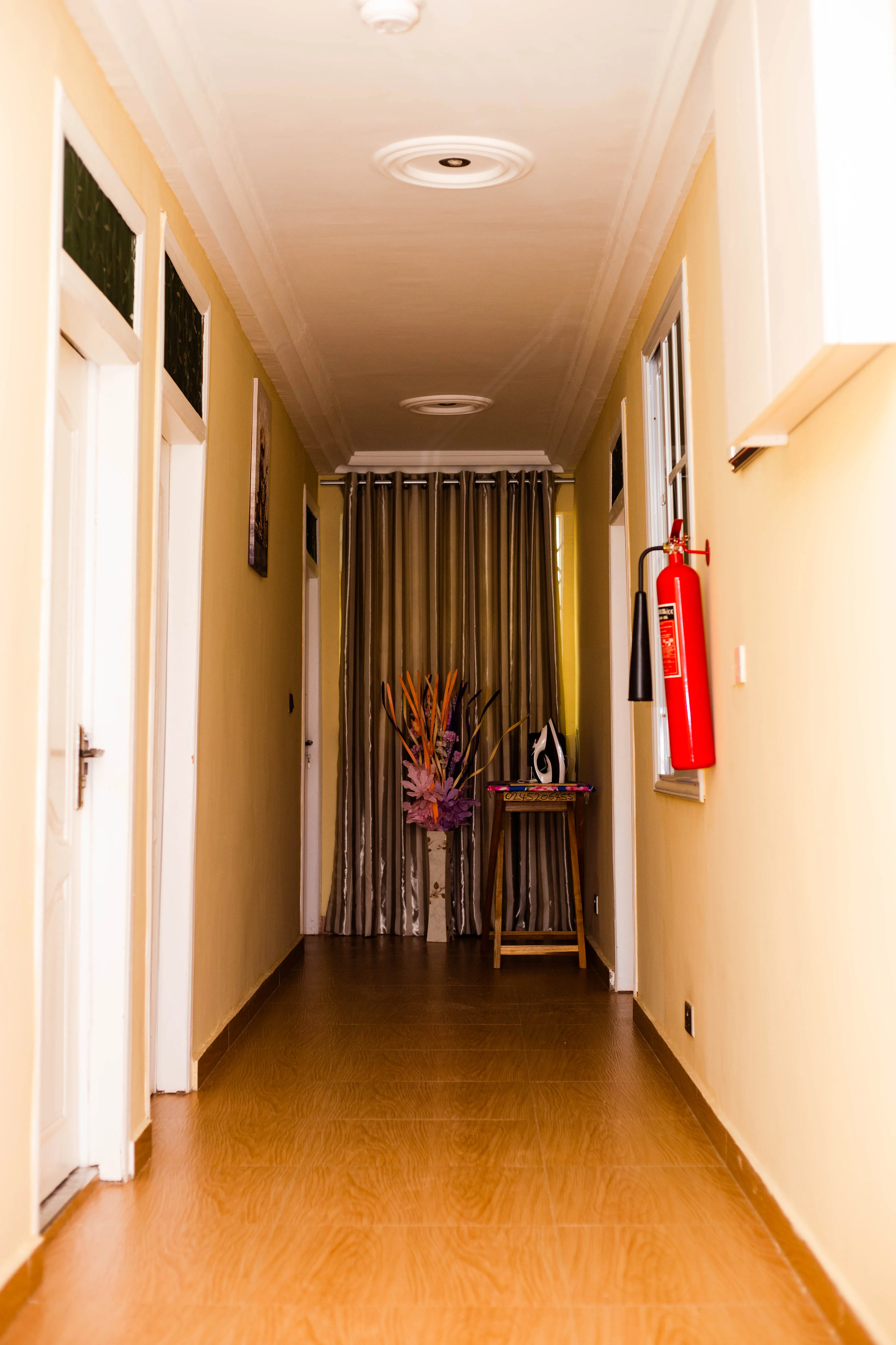 Interior corridor connecting bedrooms and shared spaces