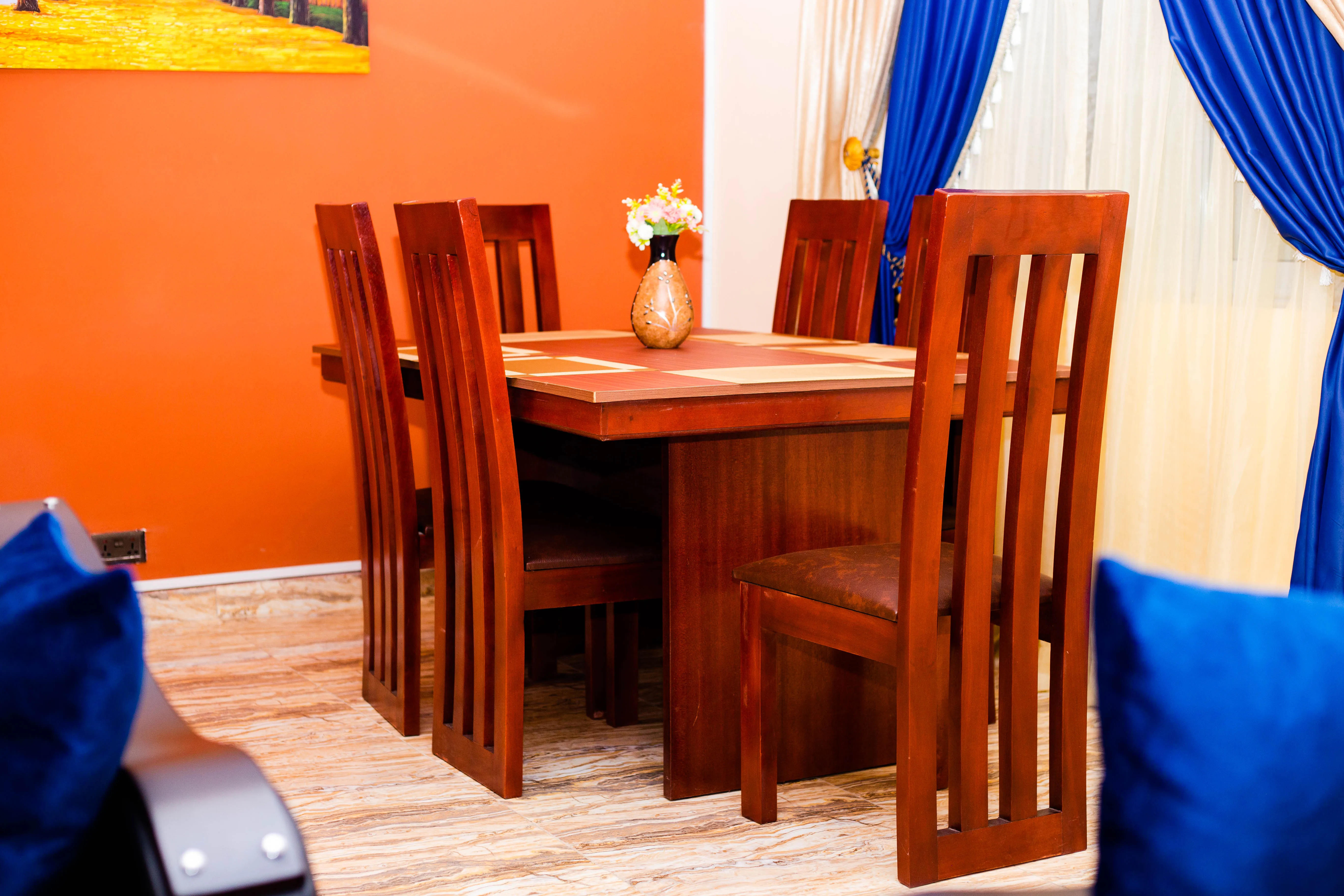 Wooden dining area within a furnished apartment